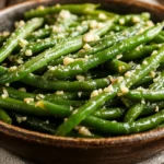 Seasoned green beans with garlic and Parmesan served in a bowl.