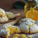 Soft and chewy orange olive oil crinkle cookies with powdered sugar.